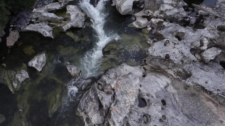 Water rushes into a rocky river bed