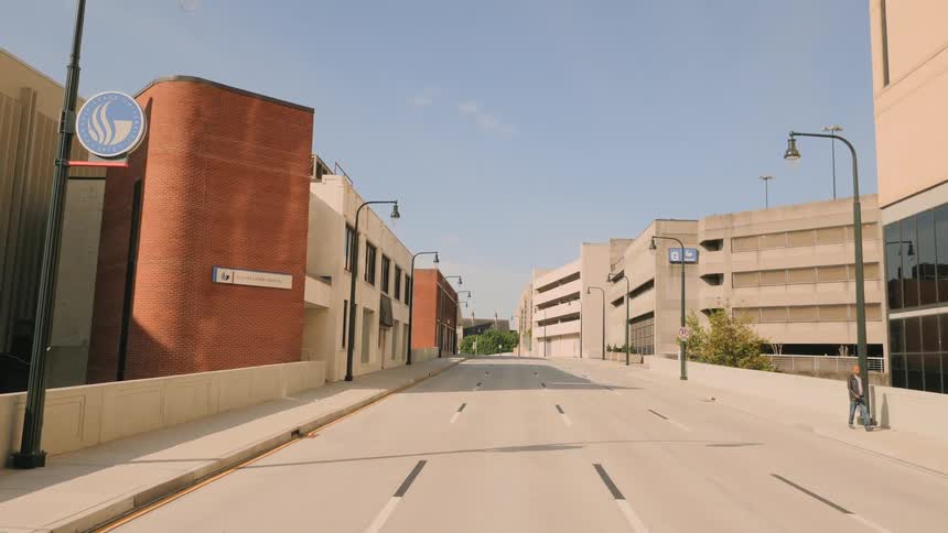 A man walks on a quiet road