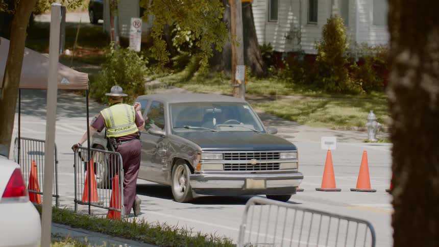 A sheriff signaling to a vehicle to come forward