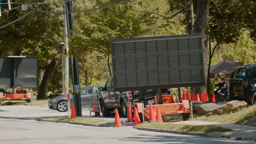 A group of cars files through a medical testing location