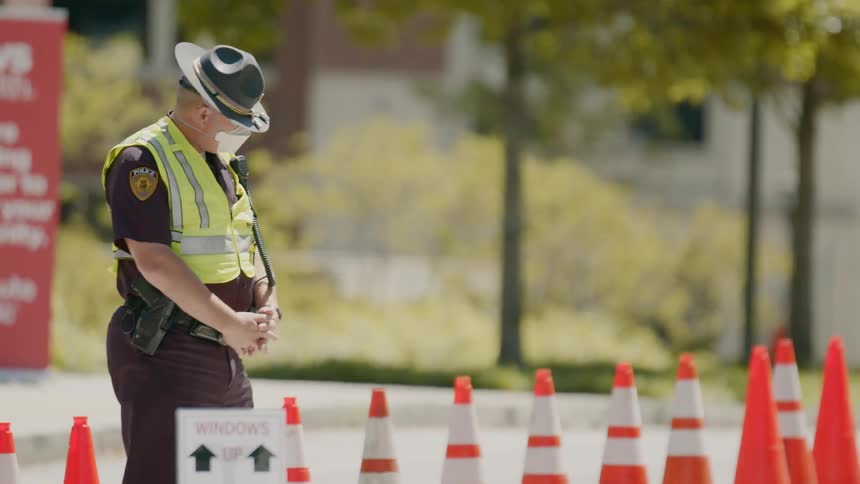 Police officer standing on a control point at city street in daylight