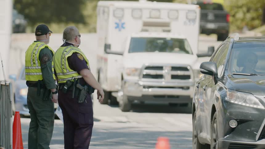 Police officers wearing face mask directing traffic in city