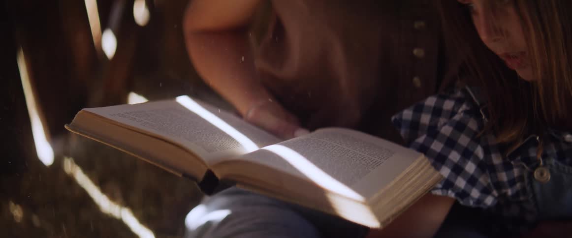 Mother and daughter read a book together