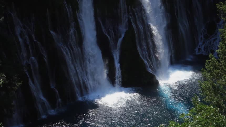 Sun shines on water flowing down a waterfall