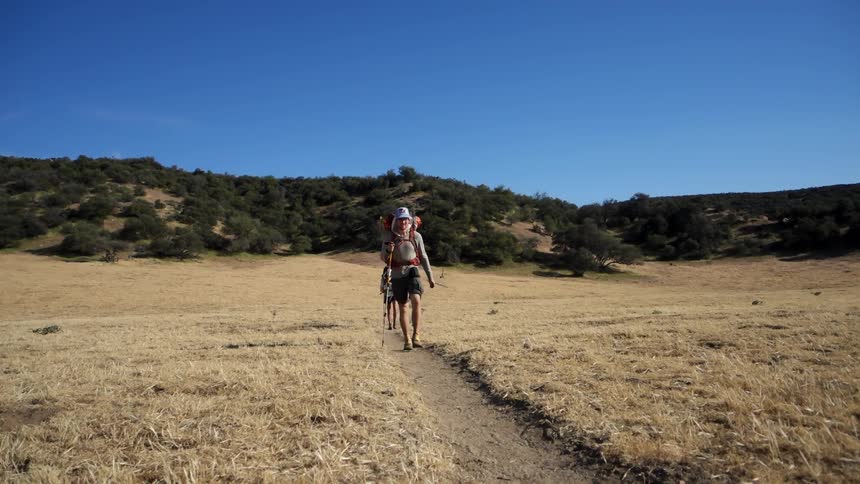Hikers walk the trail on the plain