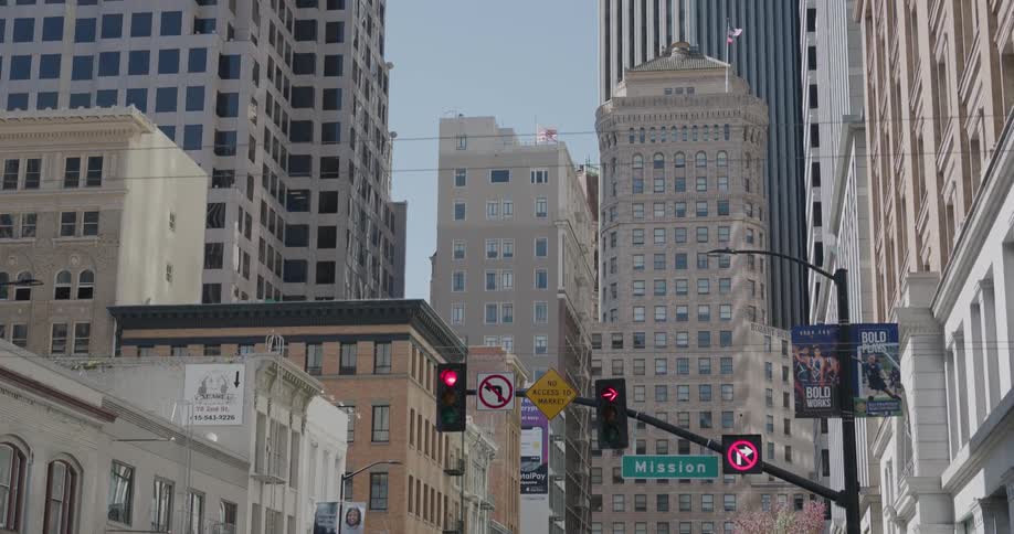 Tall buildings and store fronts fill a city street