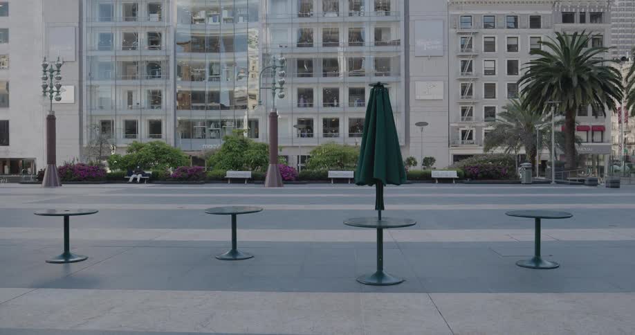 Tables sit empty in a plaza