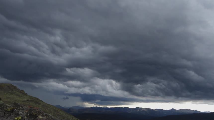 The sky above the mountains is cloudy and dark