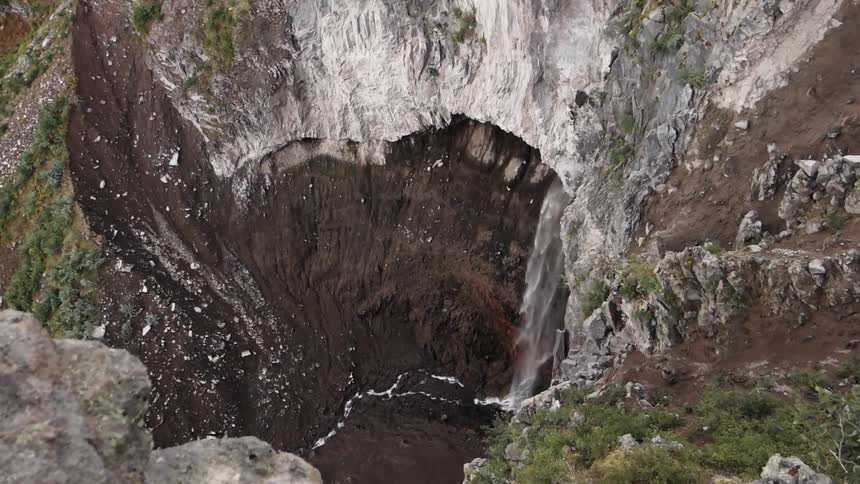 Waterfall cascades down a steep drop