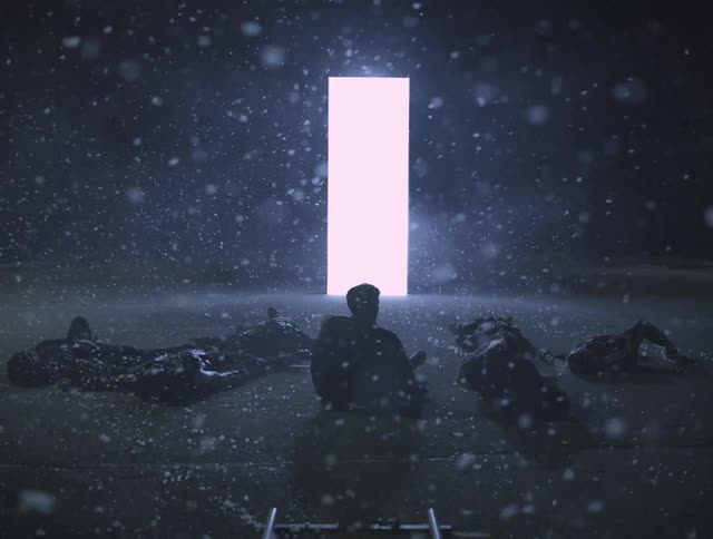 People lay around a glowing box