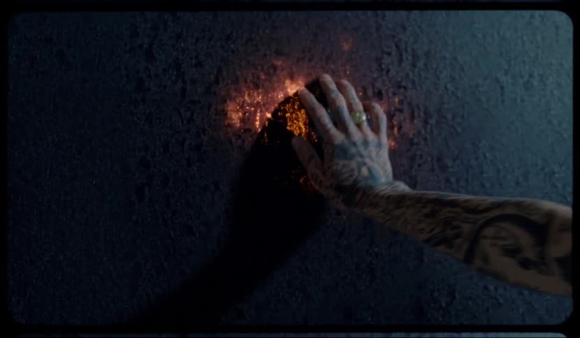 A man touches the wall and it lights up