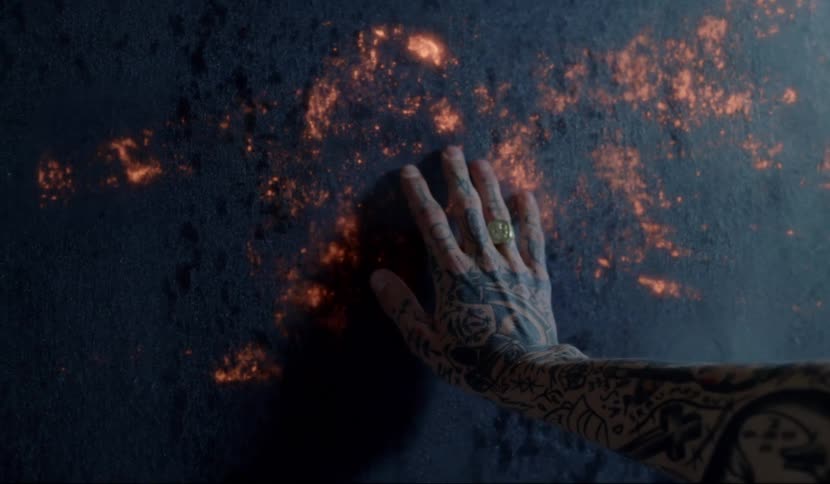 A man is touching a wall and a flame emerges