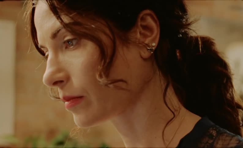 A woman with a frustrated expression looks at something