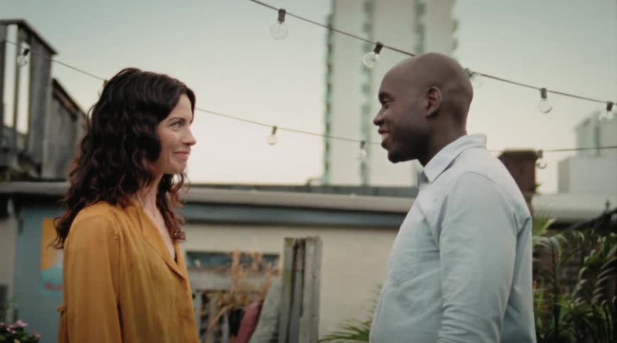 A man and a woman talking outside