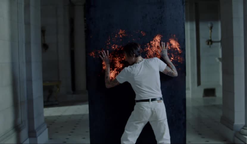 A man leans against a wall causing it to light up