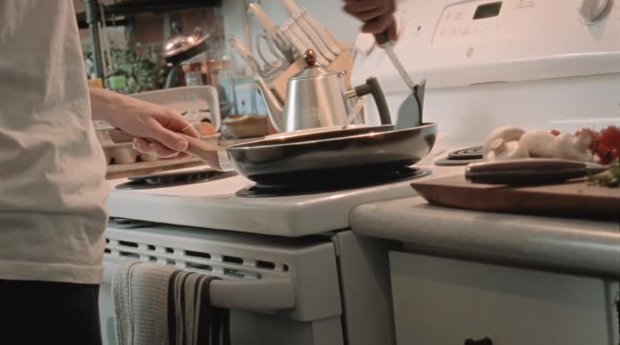 A man is cooking food on his stovetop