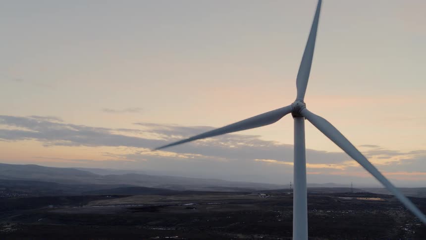 Close up traverse of a wind turbine at dusk
