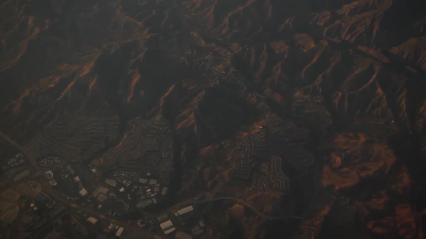 Bird's-eye-view of a community in the mountains and mountain peaks