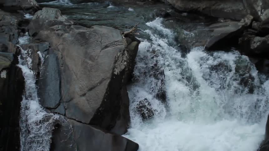 A river cascades over boulders