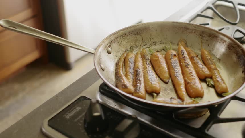 Carrots cooking in pan on kitchen at day