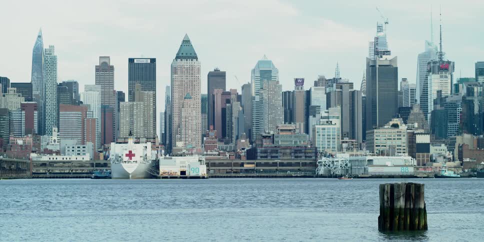 The red cross on the usns comfort is clear with the new york city skyline behind