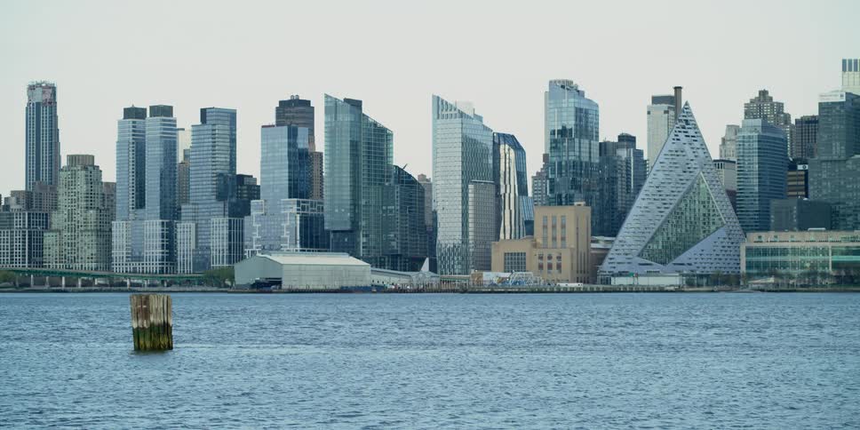 Traffic passes between skyscrapers and waterfront