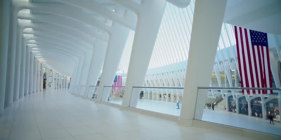 A train terminal with people and the american flag