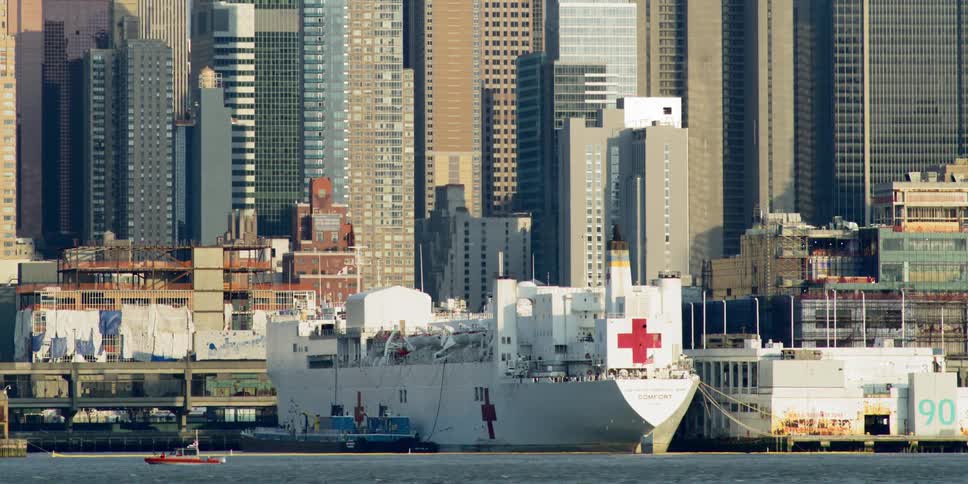 Skyline of a city with a medical boat in front