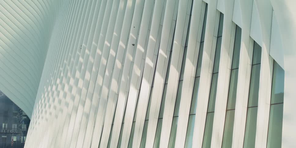 Light falls on modern building facade in city