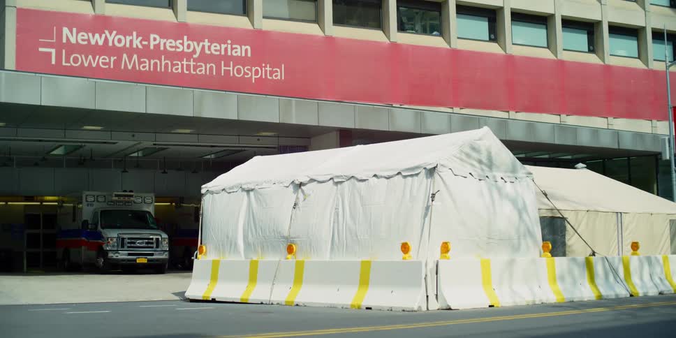 Static shot of a hospital with tents in front