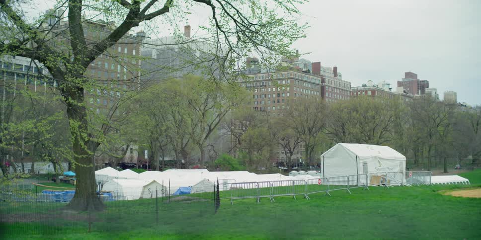 Tents sit outside buildings in a city