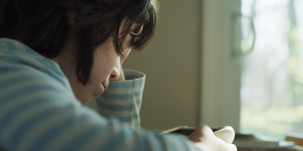 A child falls asleep while playing on a cell phone