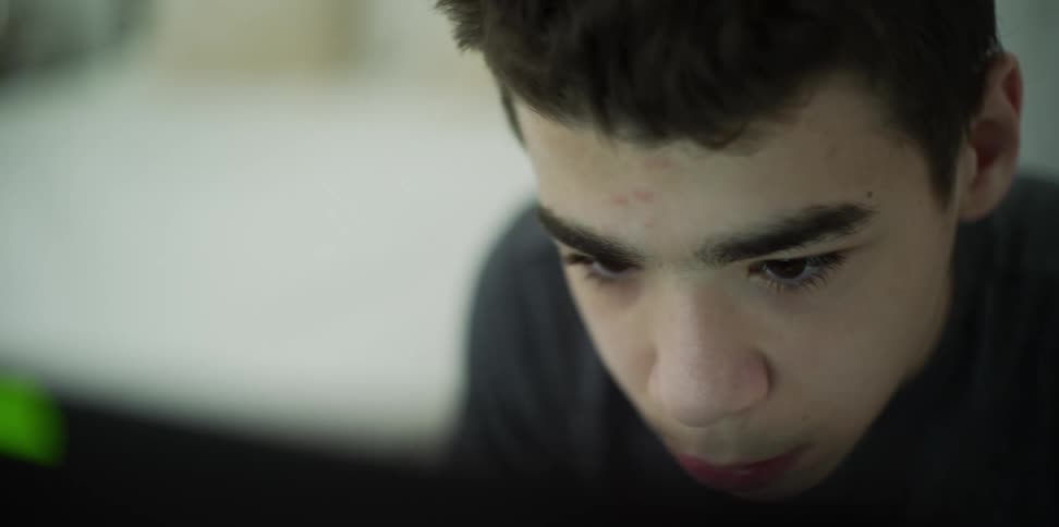 Teenager doing homework on laptop at home