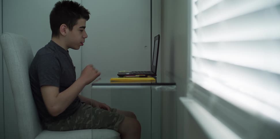 A child works on a laptop