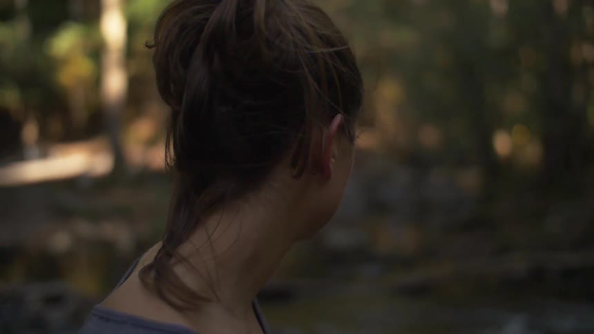 A woman stands in the forest