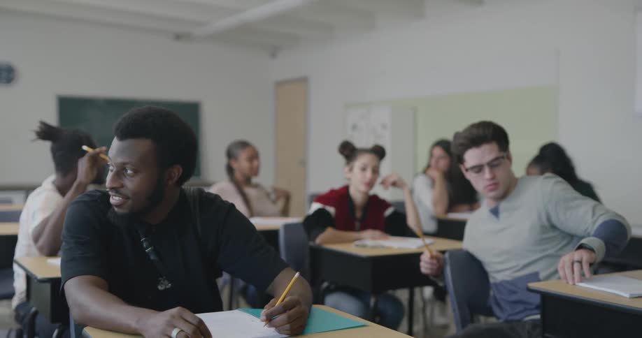 Students sitting in a classroom talking to each other