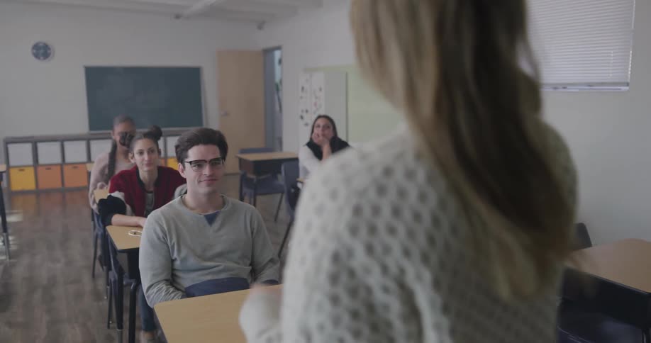 A teacher talks to her students in a classroom