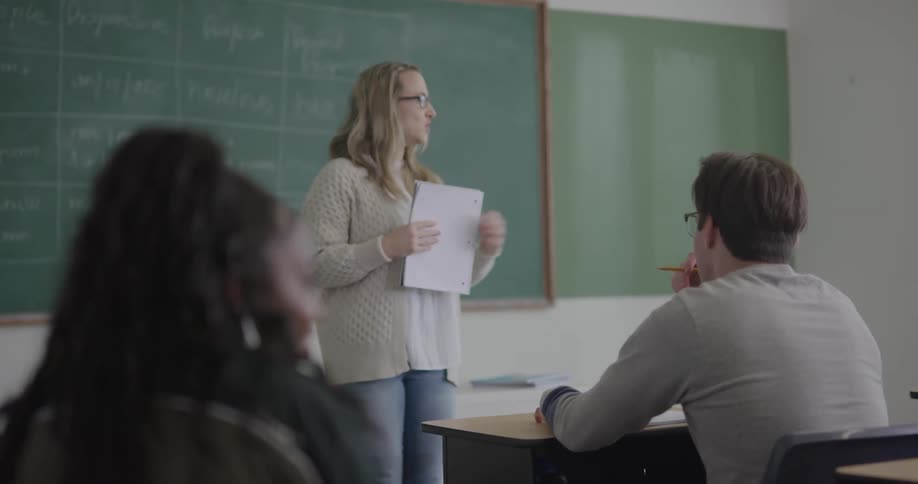 Teacher and students in classroom at day