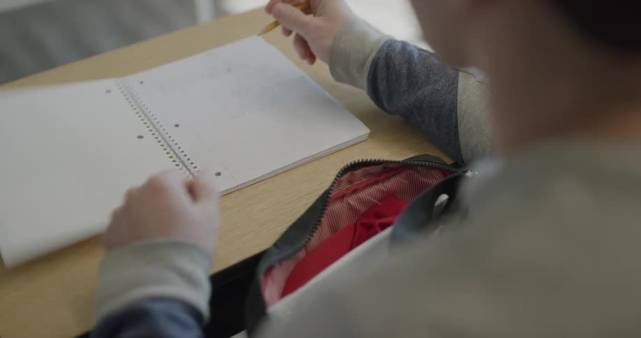 A student takes a notebook out and starts writing