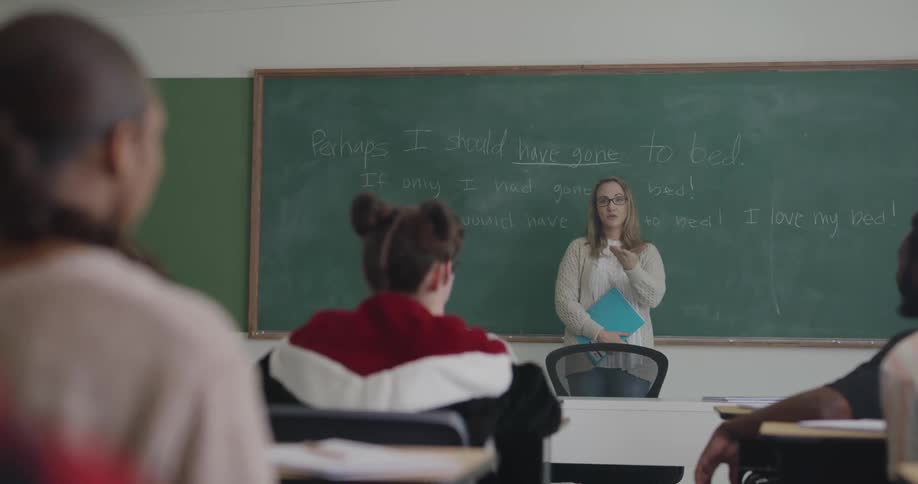 A teacher is teaching a classroom full of students