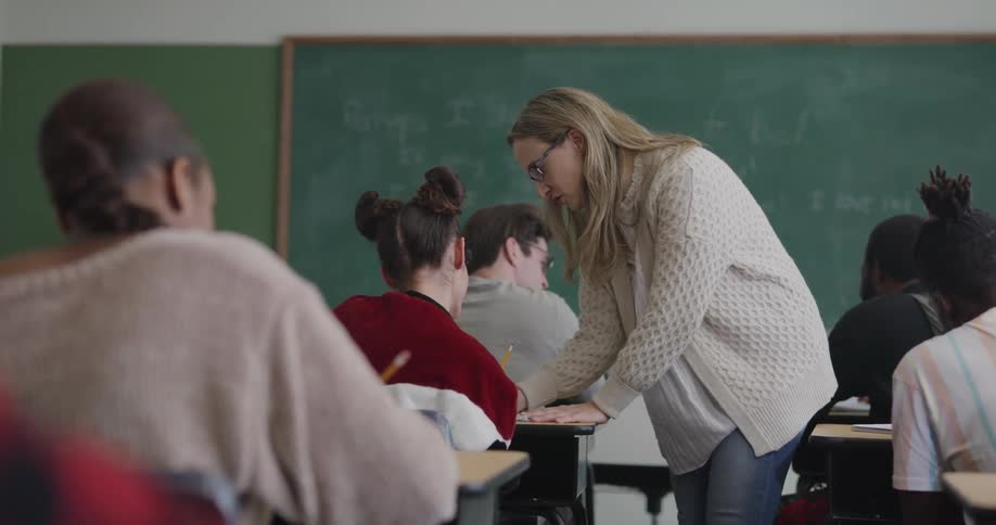 A teacher is helping students in a classroom