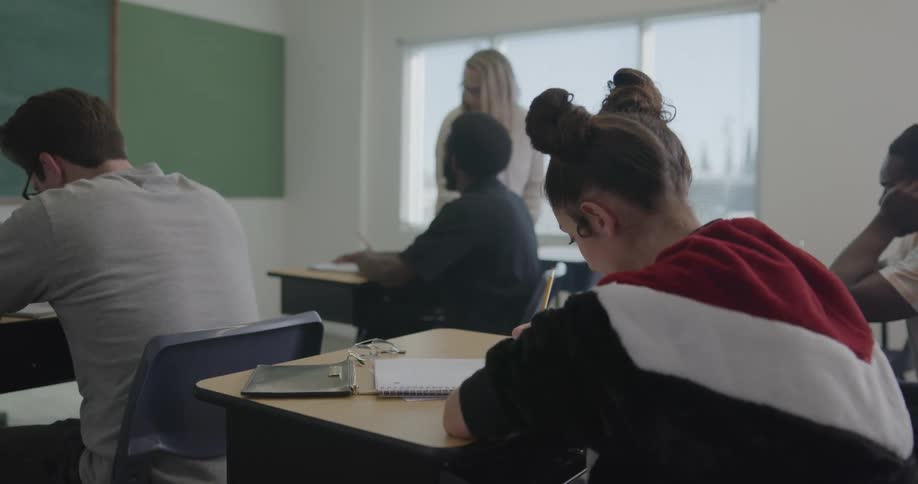 A teacher walks and talks to students in a classroom