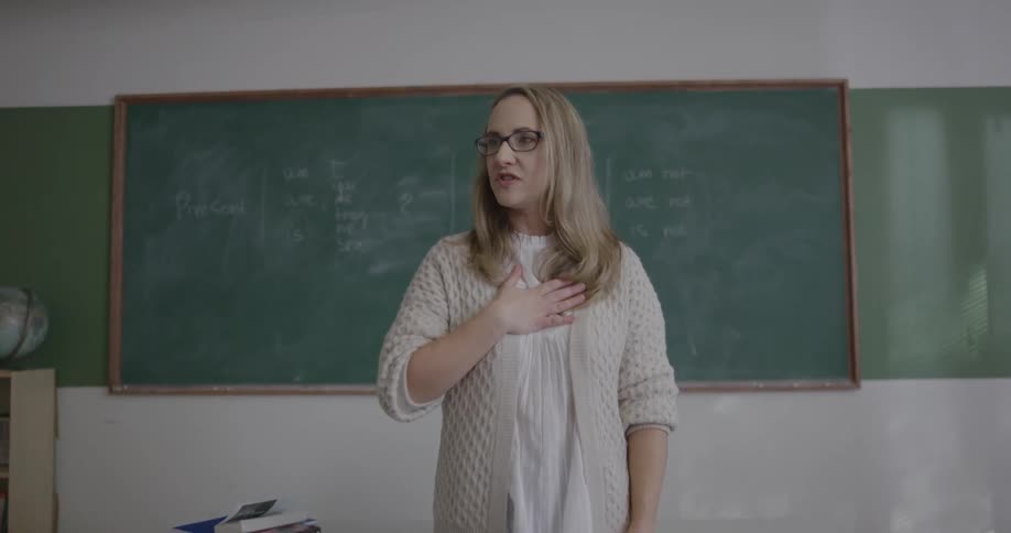 Teacher standing in front of class lecturing students