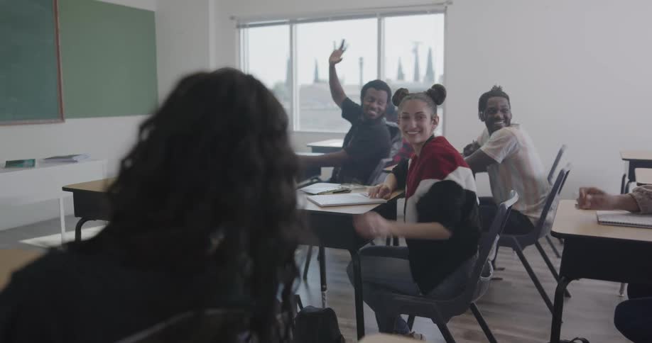 The teacher walks to her desk