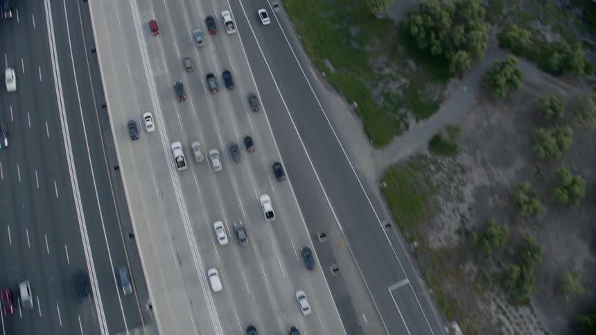 Aerial view of cars driving on busy highway at day