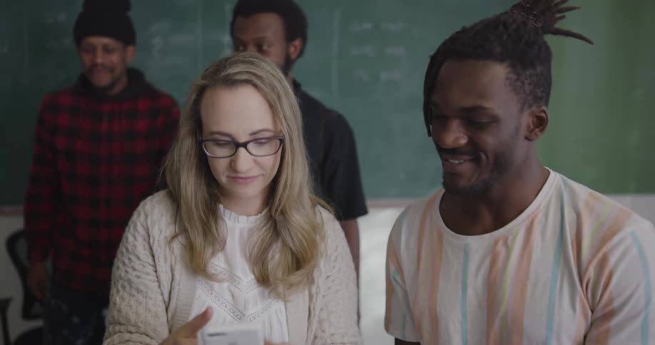 Teacher taking a selfie with students then posting on social media