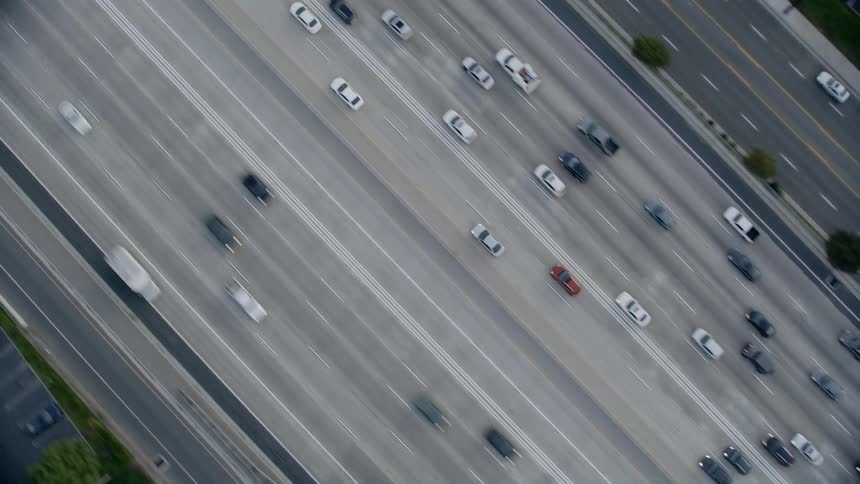 Aerial view of cars driving on highway at day