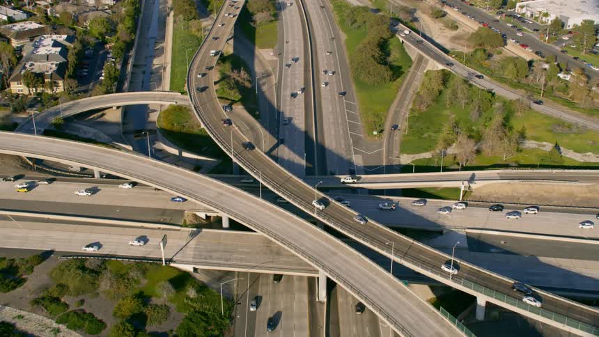 Aerial view of a busy freeway overpass in slow motion