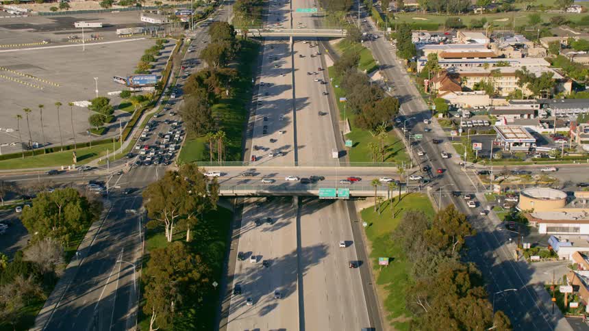 A highway with vehicles trees and buildings
