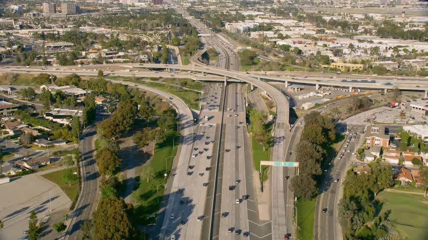 Traffic moving through highway intersection at day